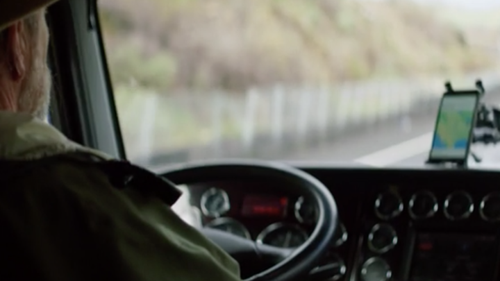 A view from behind of a person driving a truck