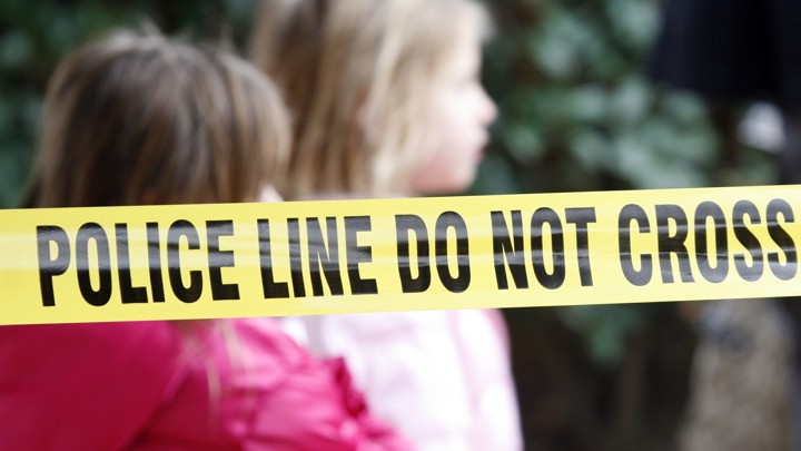 Yellow police tape stretched around a crime scene