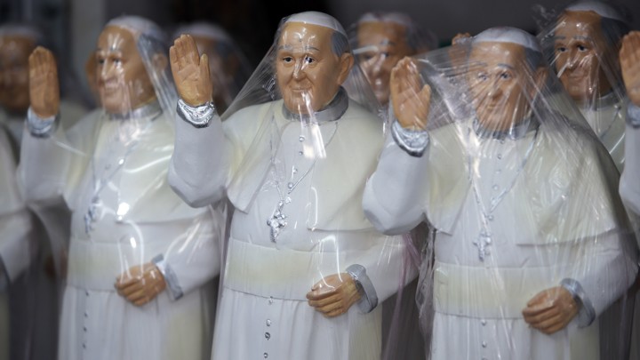 Plastic covered statues of Pope Francis stand for sale at a shop in Bogota, Colombia.