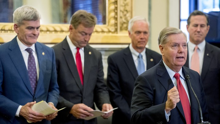 Senator Lindsey Graham speaks at a podium.