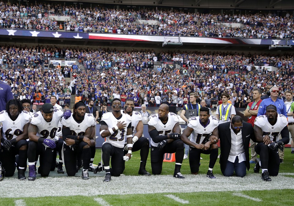 Baltimore Ravens players, including former player Ray Lewis, kneel during the playing of the U.S. national anthem before an NFL football game against the Jacksonville Jaguars at Wembley Stadium in London, Sept. 24.