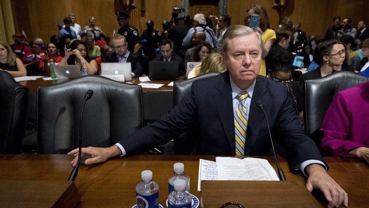 Senator Lindsey Graham sits in a hearing room as he testifies in support of his Obamacare repeal bill.