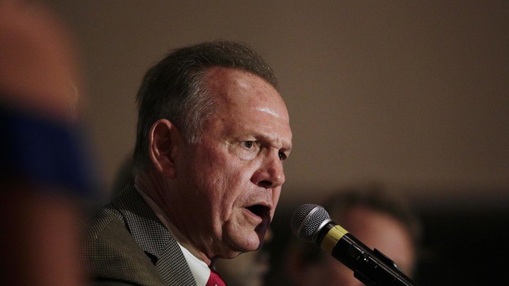 Former Alabama chief justice and U.S. Senate candidate Roy Moore speaks into a microphone during his election party on September 26.