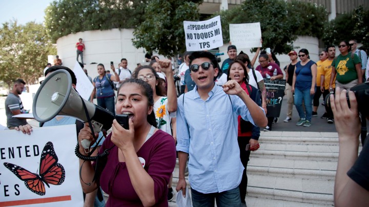 Students are seen with megaphones and signs, protesting.