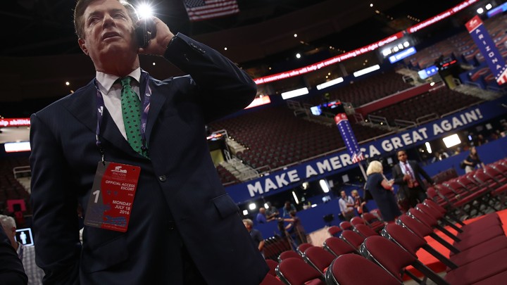 Former Trump campaign chairman Paul Manafort takes a phone call on the floor of the Republican National Convention in 2016.