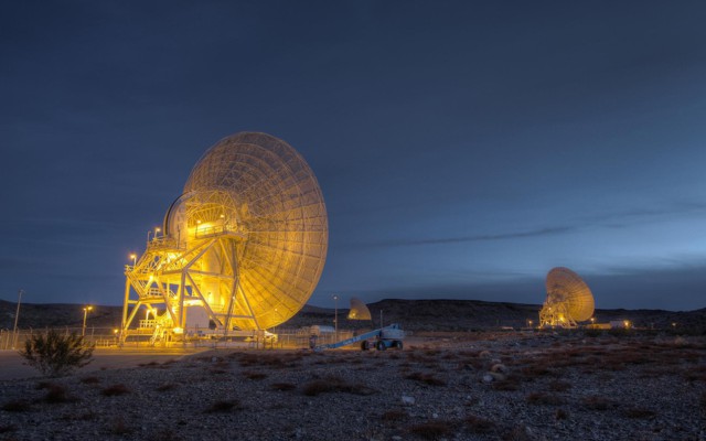 Large satellites in the desert at night