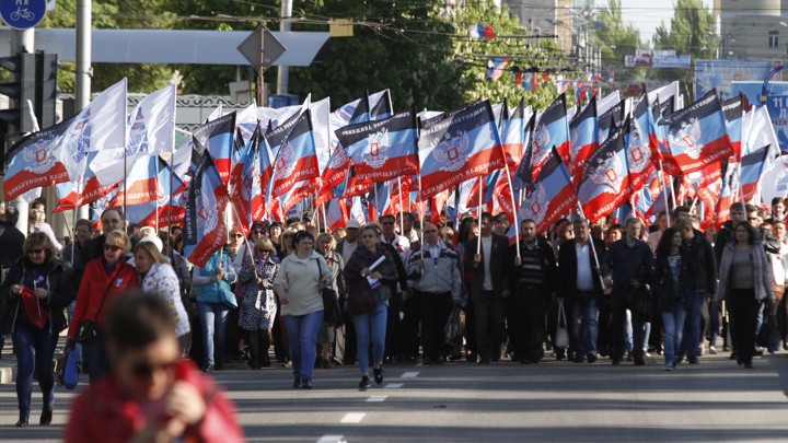 People carry flags of the self-proclaimed Donetsk People's Republic.