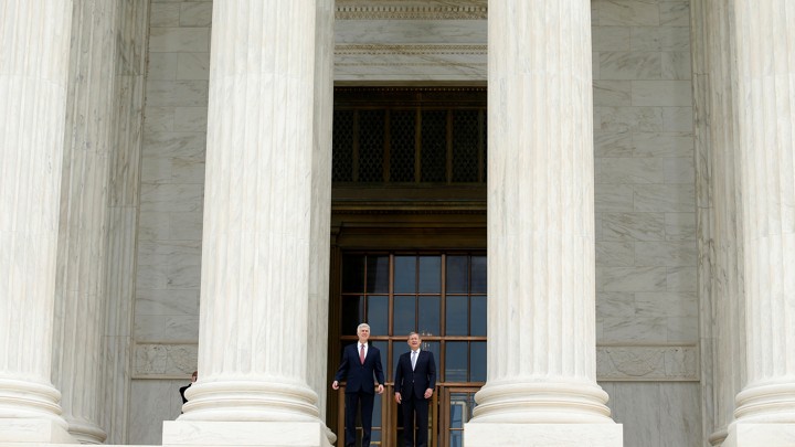 Justice Neil Gorsuch and Chief Justice John Roberts stand on the U.S. Supreme Court building steps in June.