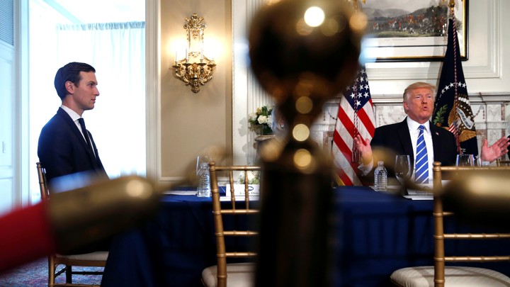 Jared Kushner sits at a table with Donald Trump.