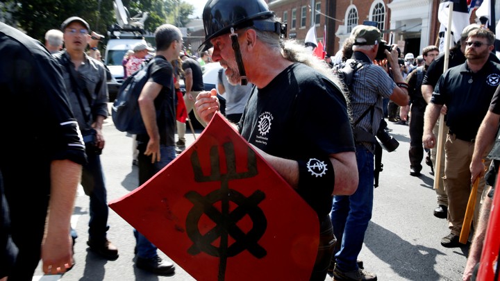 White supremacist in helmet holds shield in Charlottesville, VA.