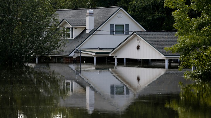 A two-story house halfway underwater