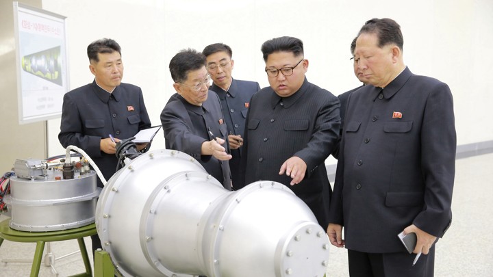 Kim Jong Un and North Korean officials examine what appears to be a missile