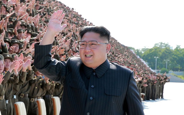 Kim Jong Un waves and smiles 