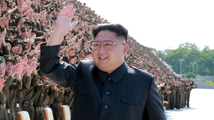 Kim Jong Un waves and smiles