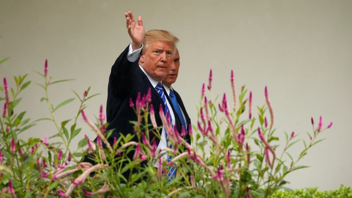 Donald Trump waves to photographers.