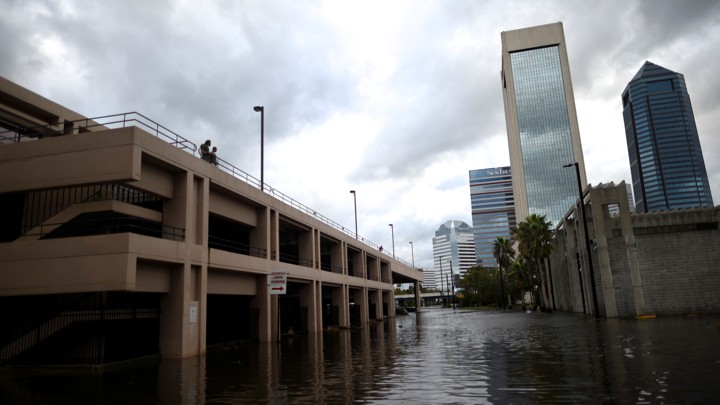 A couple looks at flood waters in Jacksonville, Florida on Monday, September 11, 2017.