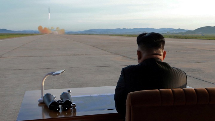 Kim Jong Un watches the launch of a Hwasong-12 missile.