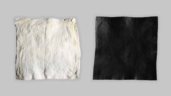 A square of white raw hide and a square of black dyed hide