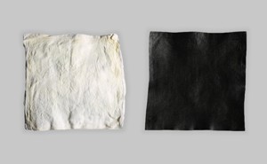 A square of white raw hide and a square of black dyed hide