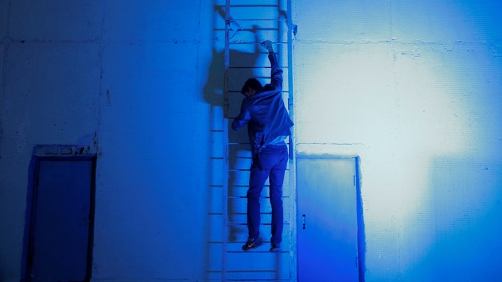 A man climbs a ladder.