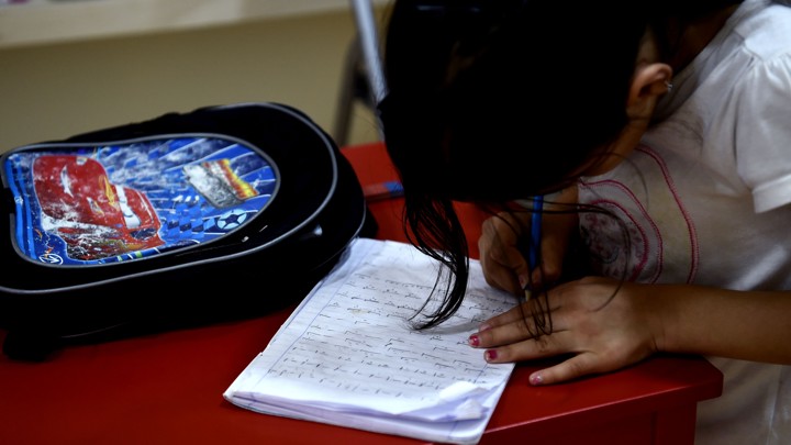 A girl writes a letter.