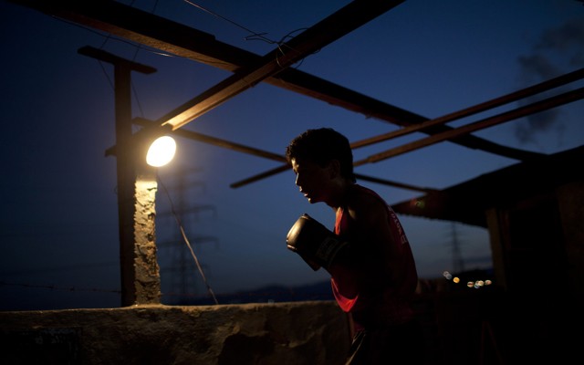 A boy wearing a boxing glove 