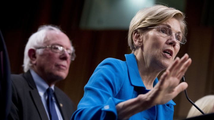 Democratic Senator Elizabeth Warren, accompanied by Senator Bernie Sanders, speaks at a health-care news conference on Capitol Hill.