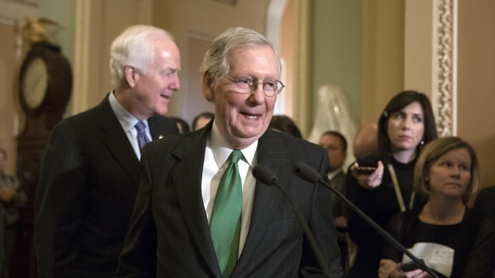 Senate Majority Leader Mitch McConnell steps up to a microphone.