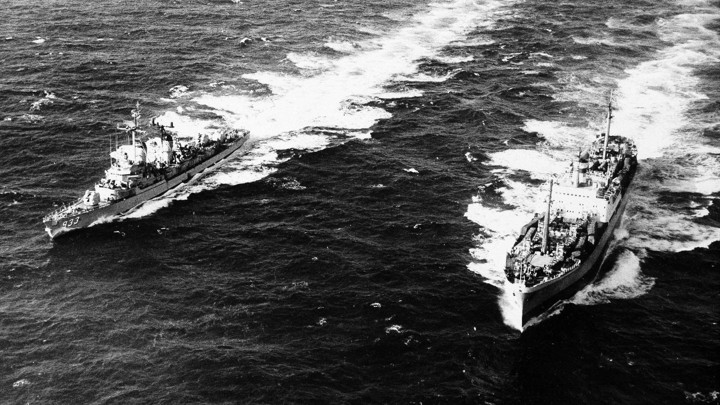 The U.S. Destroyer, Barry, pulls alongside the Russian freighter, Anosov, to inspect cargo, in the Atlantic Ocean.
