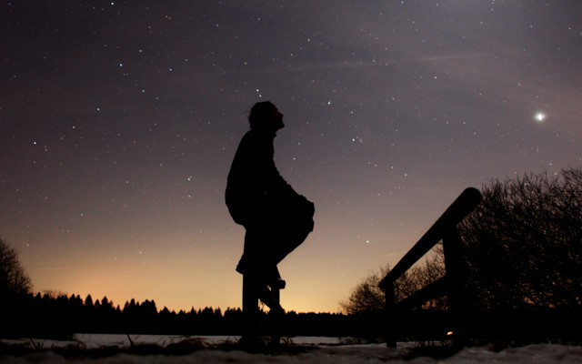 A person in silhouette against a starry sky