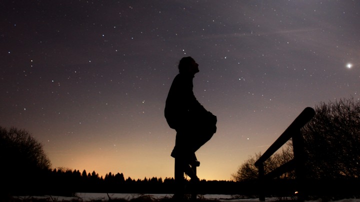 A person in silhouette against a starry sky