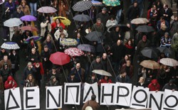 Protesters march under umbrellas during an anti-government rally