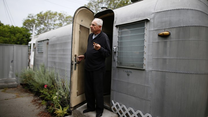 A man standing in the doorway of his mobile home