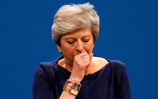 Prime Minister Theresa May coughs as she addresses the Conservative Party conference.