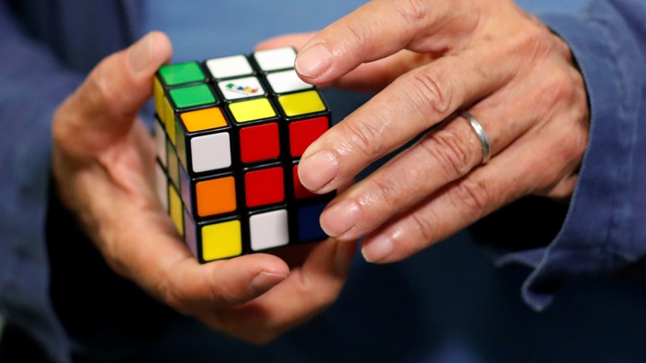 A man holds a Rubik's cube