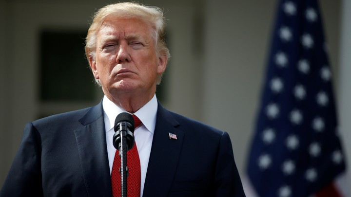 Donald Trump in front of a microphone.