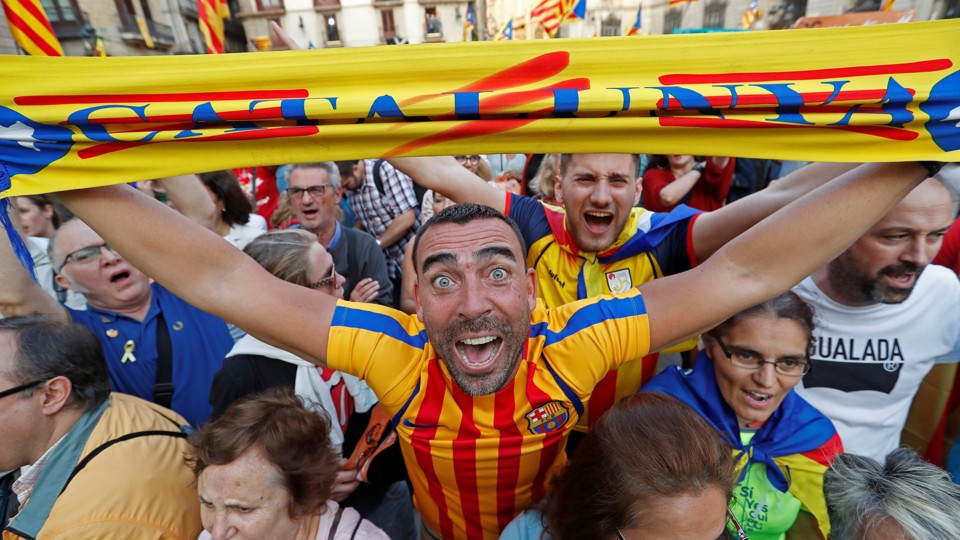 People in Barcelona react positively to the Catalan parliament's declaration of independence from Spain.