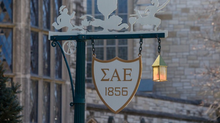 A sign on a lamppost with the initials of Sigma Alpha Epsilon on it