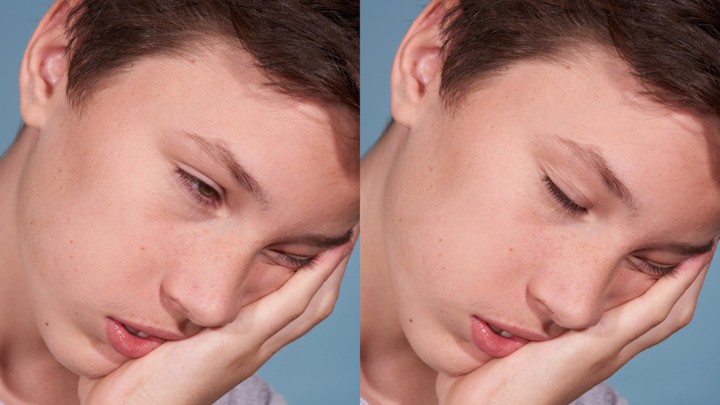 A man falls asleep with his chin in his hand.