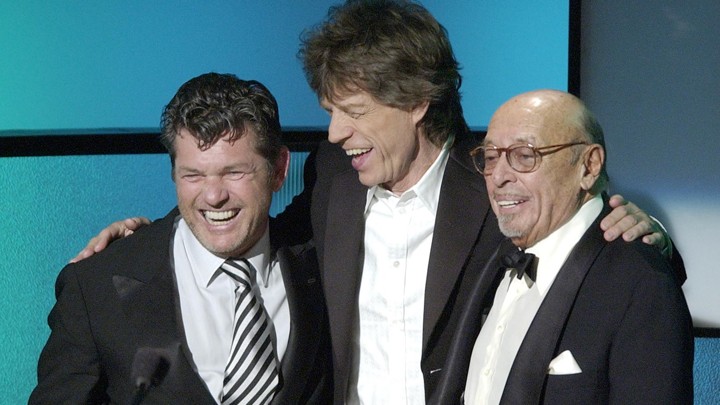 Jann Wenner, left, accepts his Rock and Roll Hall of Fame induction award from Mick Jagger and Atlantic Records founder Ahmet Ertegun 2004.
