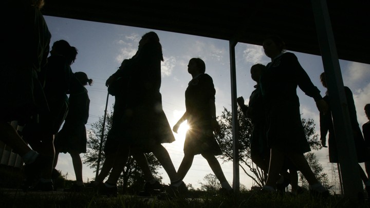 Students walk on campus in the morning.
