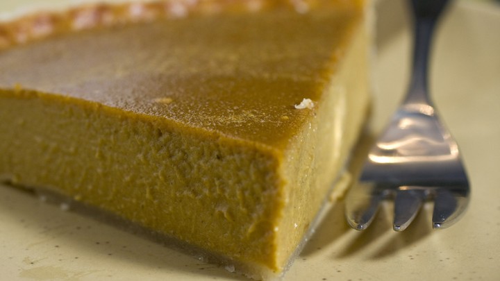 A slice of pumpkin pie and a fork