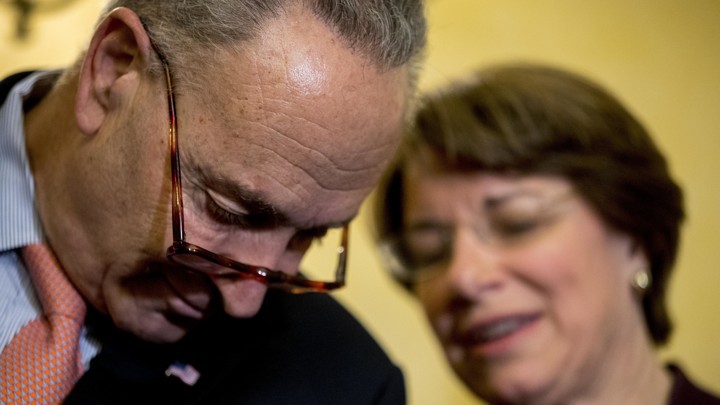 Senate Minority Leader Chuck Schumer and Senator Amy Klobuchar speak together during a news conference.