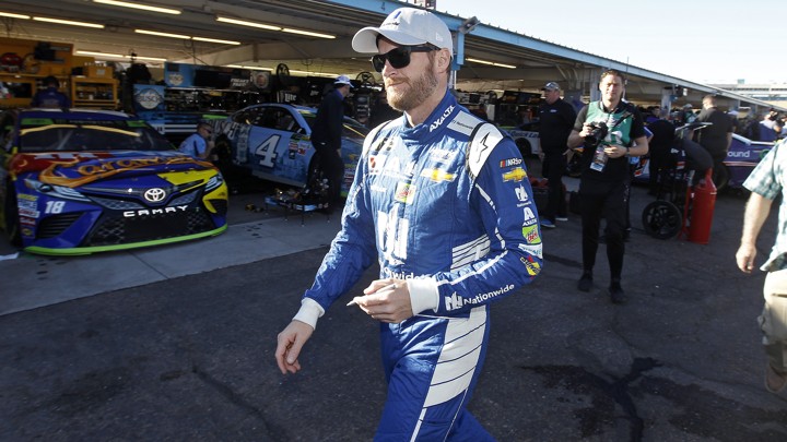 Dale Earnhardt Jr. walks through the garage area before practice for the NASCAR Cup Series auto race at Phoenix International Raceway
