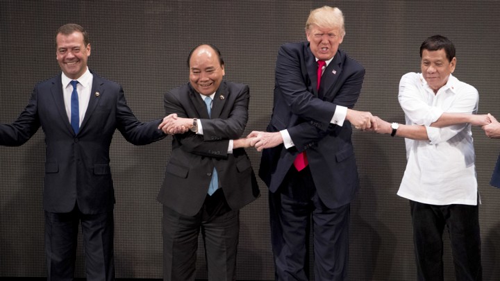 President Trump takes part in the "family photo" at the ASEAN summit.