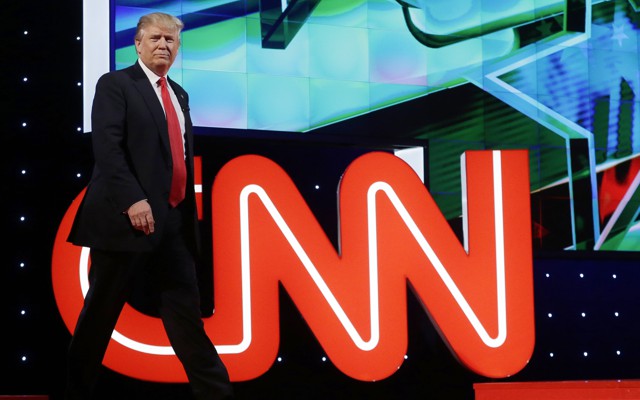 Donald Trump in front of the CNN logo