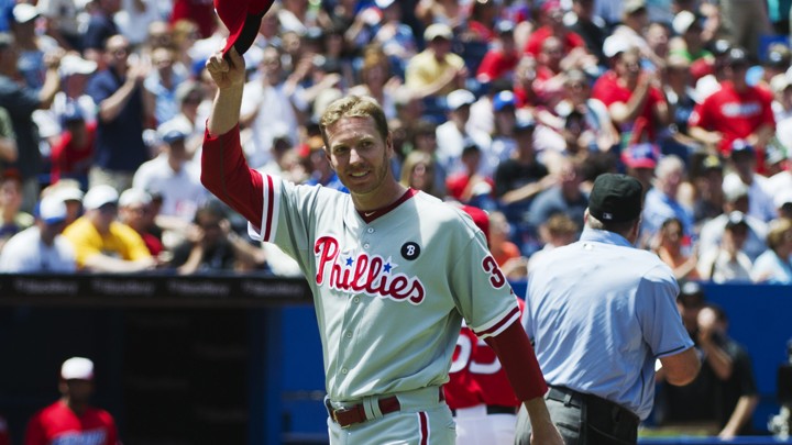 The Philadelphia Phillies pitcher Roy Halladay smiles and tips his hat to the crowd before his team plays the Toronto Blue Jays in a 2011 game in Toronto.