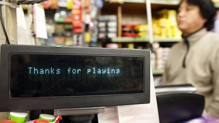 A shopkeeper waits for customers to buy Powerball lottery tickets in New York in November 2012.