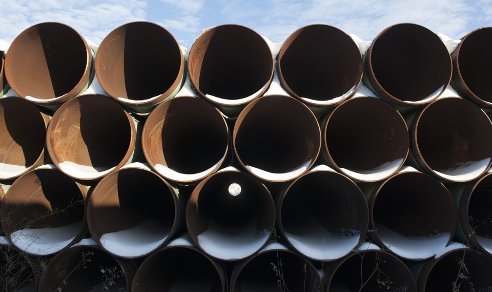 A stack of pipes that have collected snow