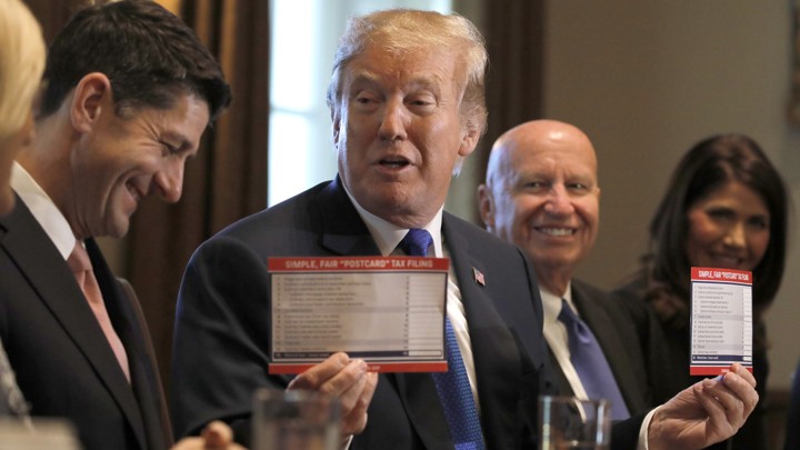 President Trump holds sample tax forms